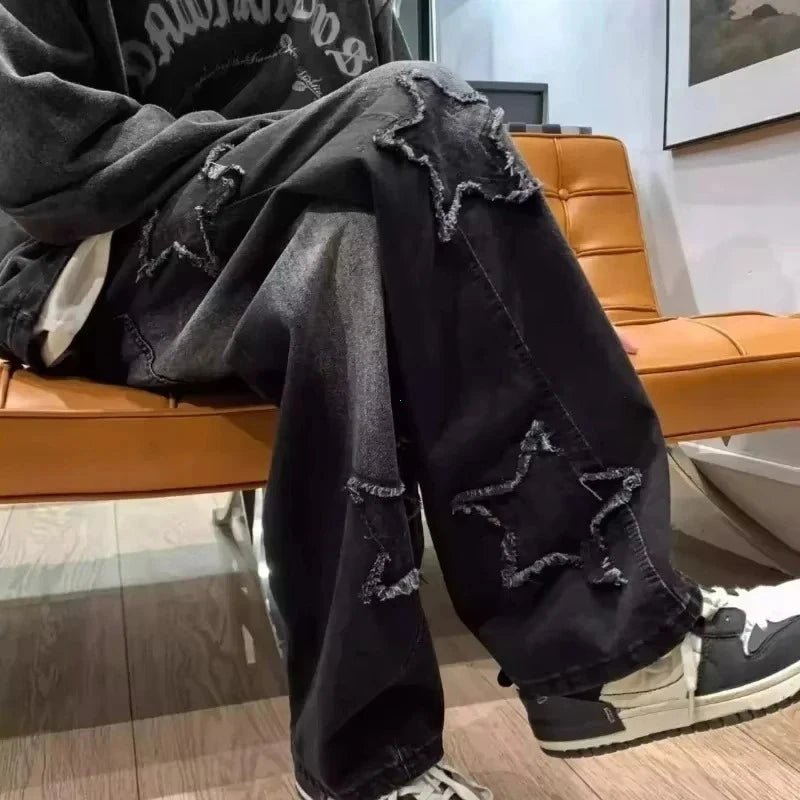 Black ripped jeans with star cutouts, paired with sneakers, styled for modern casual wear