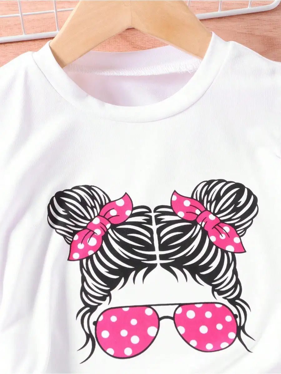 Young girls white T-shirt with portrait graphic of braided hair buns, pink polka-dot sunglasses and pink bows