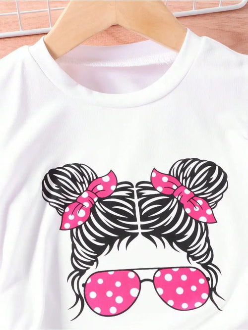 Young girls white T-shirt with portrait graphic of braided hair buns, pink polka-dot sunglasses and pink bows