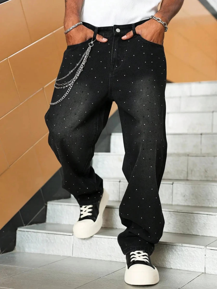 Black dotted jeans with silver chain accessory, paired with white sneakers for modern streetwear style