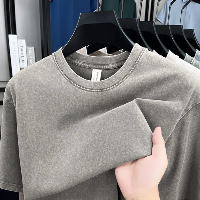 Gray crewneck t-shirt on black hanger, soft fabric, modern casual style for everyday wear